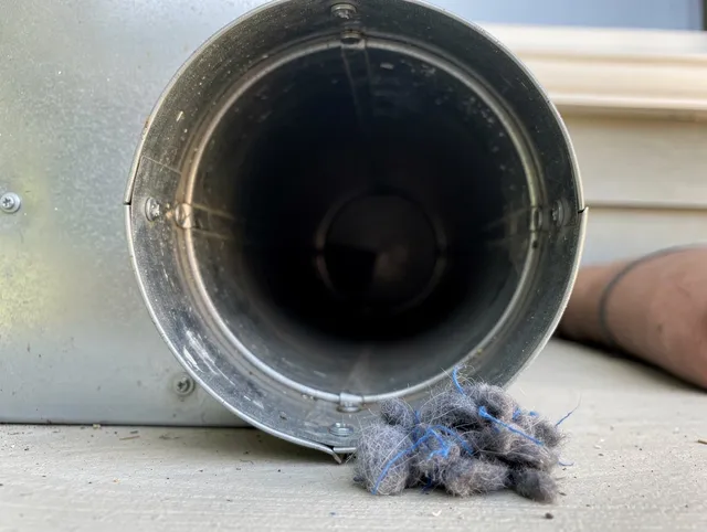 Wellington Dryer Vent Cleaning technician using specialized equipment to clear severe dryer vent blockage in Wellington